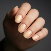 Apricot Candy Glow rubber base gel NZ applied on short rounded off square - soft apricot pastel shade with a hint of shimmer by Nails Factor Supplies