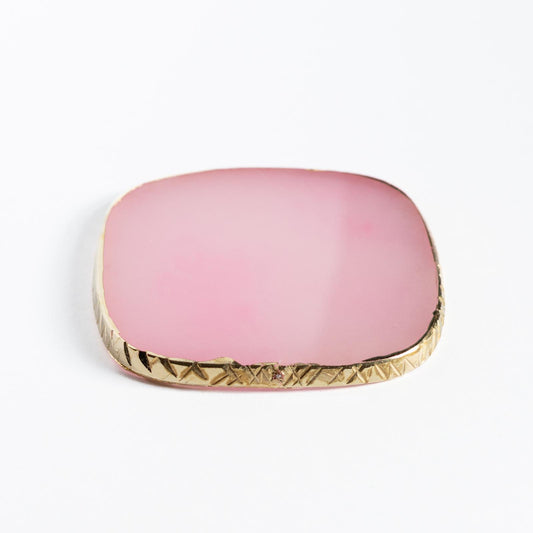 Pink square compact with gold trim on a white background